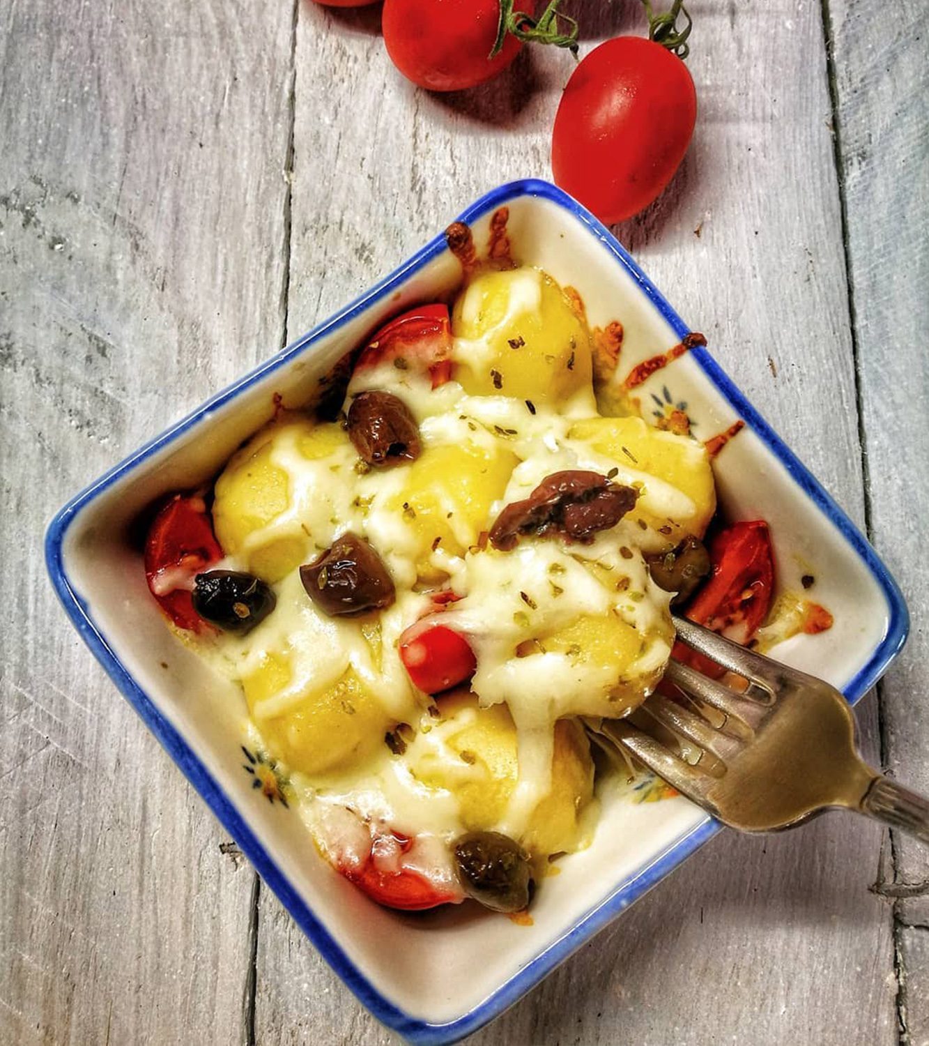 Gnocchi stuffed with tomato and mozzarella with oven roasted Piccadilly tomatoes and taggiasca olives